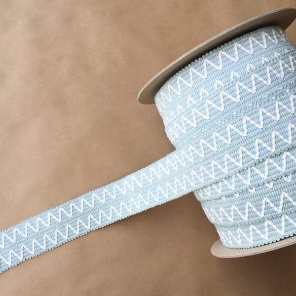 A spool of Essex Outdoor Tapes 2IN blue and white striped ribbon.