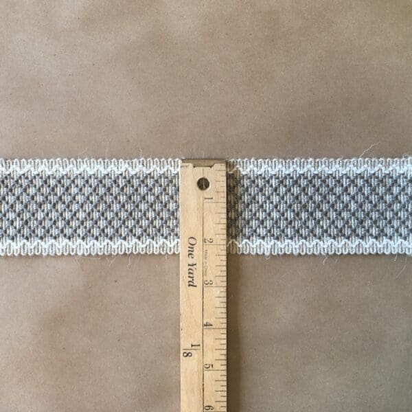 A Camlet and Camlet Wool 2.25 next to a piece of fabric with a white stripe.