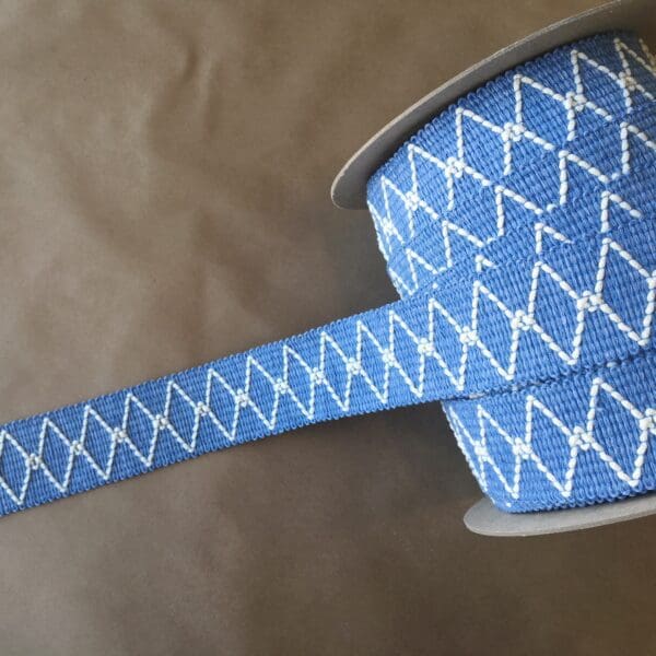 A blue and white striped Charleston Outdoor/Indoor Tape on a spool.