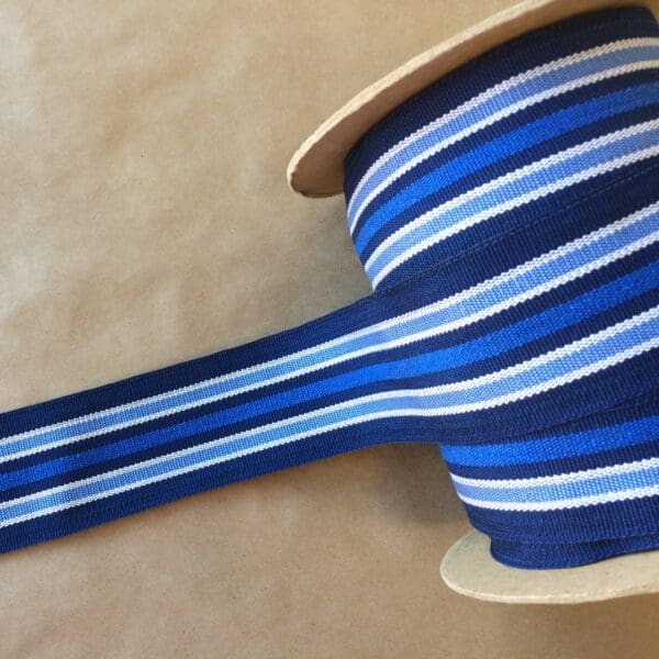A spool of Eden 2 1/4 blue and white striped ribbon.