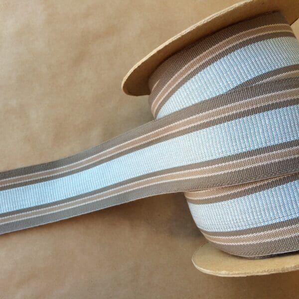 A blue and brown striped ribbon on top of an Eden 2 1/4 spool.