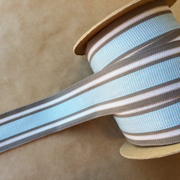 A spool of Eden 2 1/4 blue and white striped ribbon.