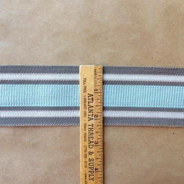 A ruler with a Eden 2 1/4 stripe on it.