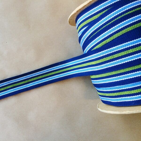 A blue and green striped Eden 1.5 and 2IN Tapes-Indoor and Outdoor ribbon on a table.