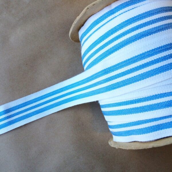 A roll of Eden 1.5 and 2IN Tapes-Indoor and Outdoor striped ribbon.