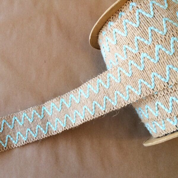 A spool of Essex 2IN ribbon with a blue chevron pattern.