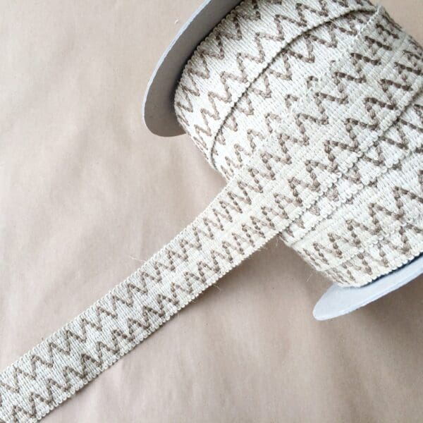 A spool of Essex 2IN brown and white zigzag ribbon.