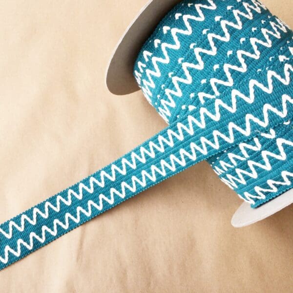 A roll of Essex 2IN teal and white chevron ribbon.