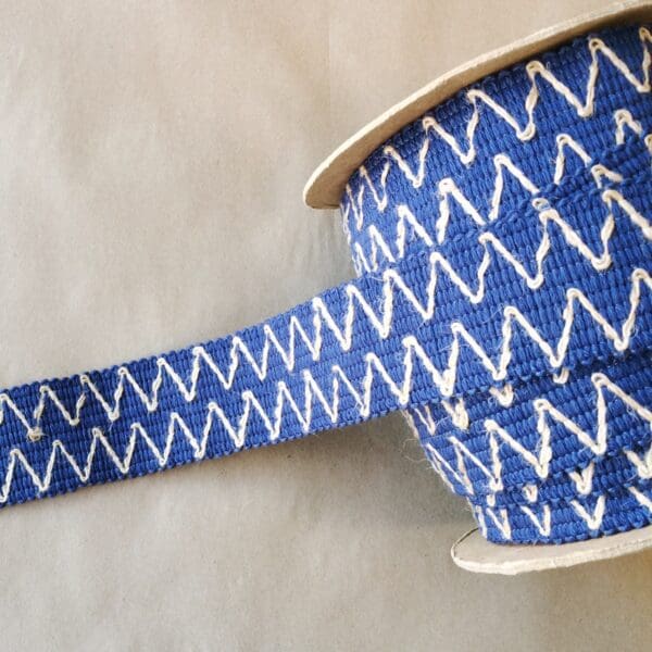 A blue and white Essex 2IN ribbon with a zig zag pattern.