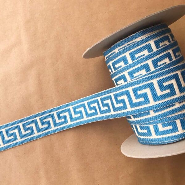 A blue and white Greek Key ribbon with a greek design on it.