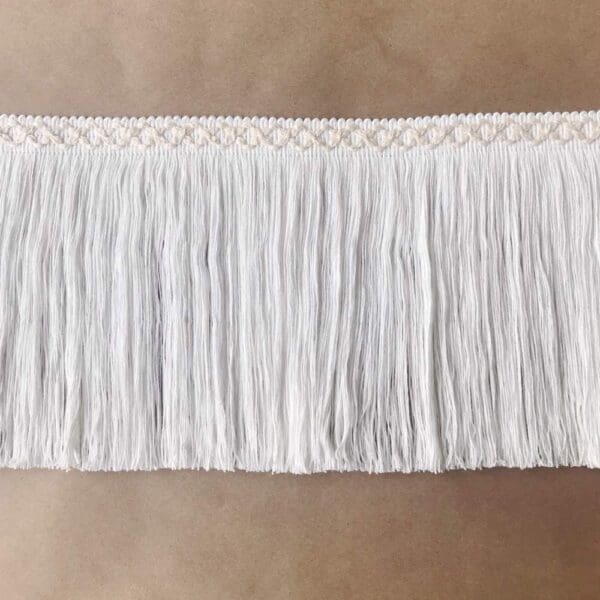 A white fringe trim on a table.
