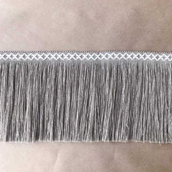 An image of a grey fringe on a table.