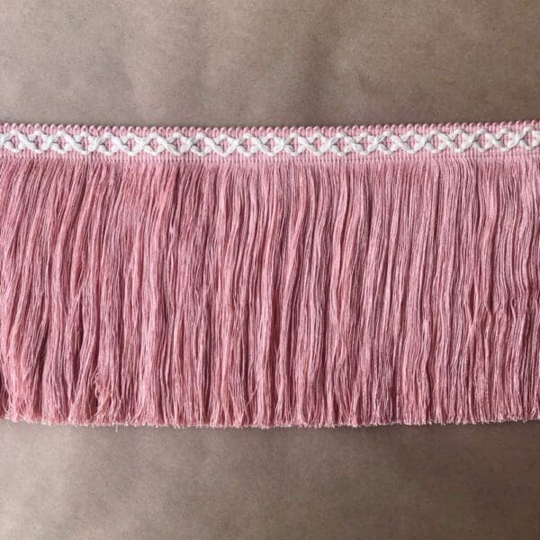 A pink fringe trim on a table.