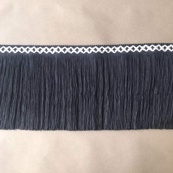 A black fringe with white trim on it.
