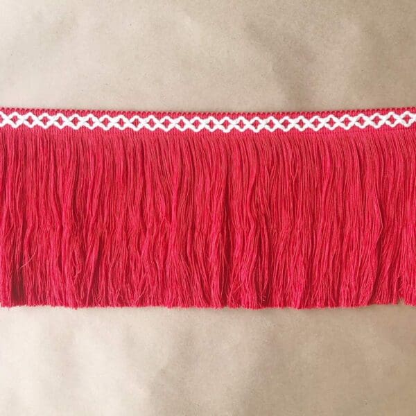 A red fringe skirt with white trim.