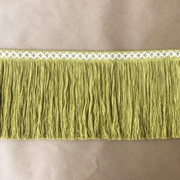 A green fringe trim on a table.