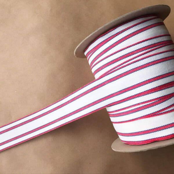 A spool of Balcony Outdoor Tapes striped ribbon.