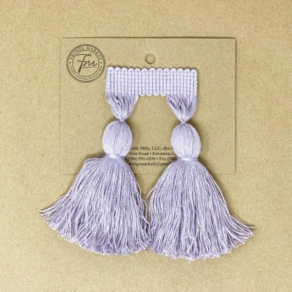 A pair of 5IN Chunky Tassel Fringe on a card.