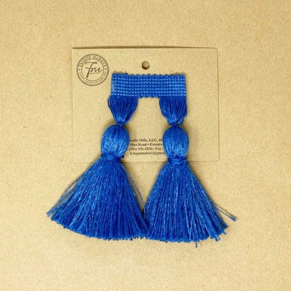 A pair of 5IN Chunky Tassel Fringe on a card.