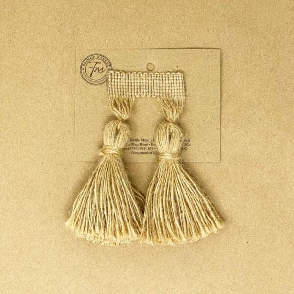 A pair of 5IN Chunky Tassel Fringe on a piece of paper.