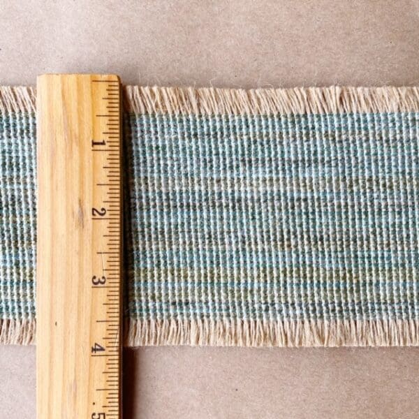 A Navajo Jute 4IN next to a piece of woven fabric.