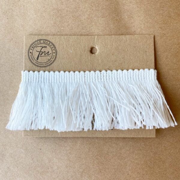 A white Outdoor 2IN Cut Brush Fringe on a card.