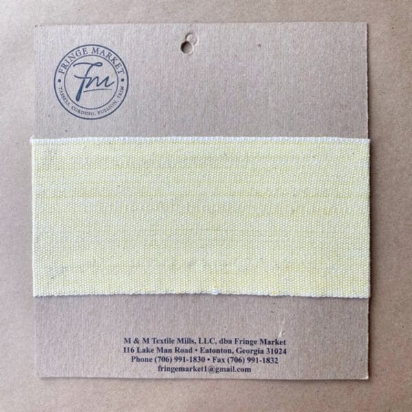 A piece of yellow fabric with a label on it.