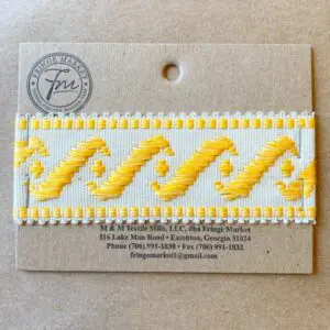 A yellow and white Surf's Up 1 3/4 IN Tape embroidered ribbon on a card.