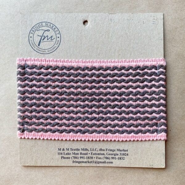 A pink and gray striped Barnsley 3 3/4 IN Tapes ribbon on a piece of paper.
