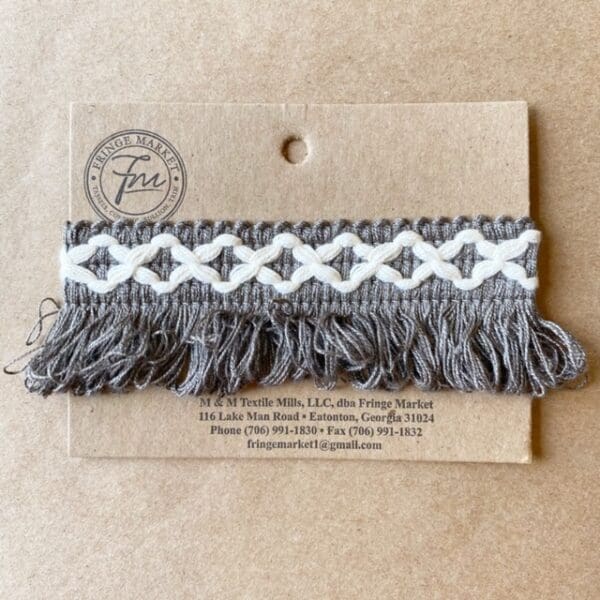 A card with a Loopy Fringe 1.5 IN tassel on it.