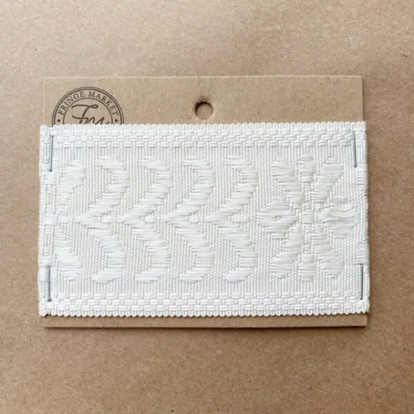 A Park Avenue Silk Braid 2.5 IN embroidered patch on a piece of cardboard.
