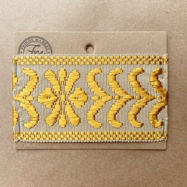 A yellow and white embroidered Park Avenue Silk Braid 2.5 IN on a piece of paper.