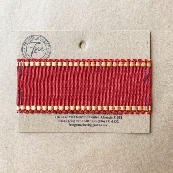 A Picot Grosgrain 1 3/4 IN ribbon with gold trim on it.