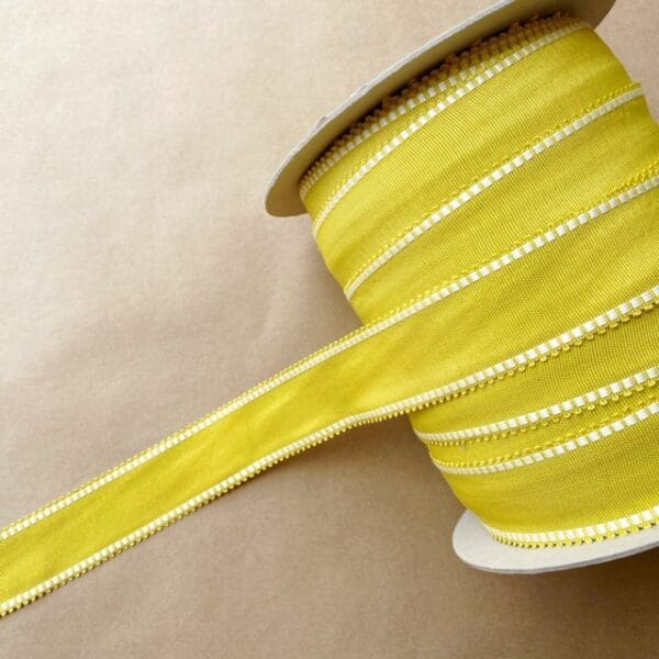A spool of Picot Grosgrain 1 3/4 IN ribbon on a table.