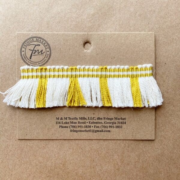 A Circus Fringe 1.25IN with a yellow and white tassel on it.