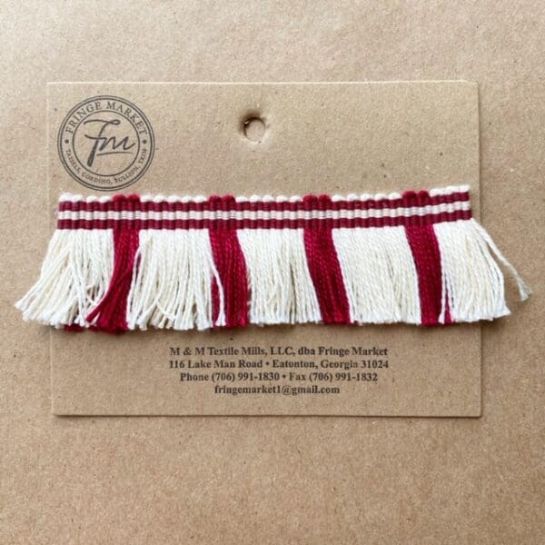 A Circus Fringe 1.25IN with red and white tassels on it.