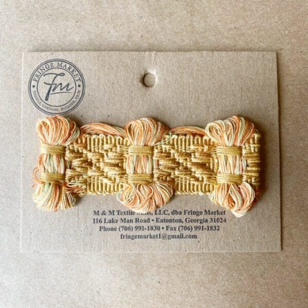 An Bow Tie Braid 1 3/4 IN hair clip on a piece of paper.