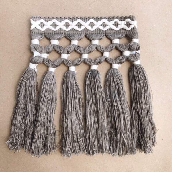 Diamond Triple Knot 6.5IN tassels hanging on a table.