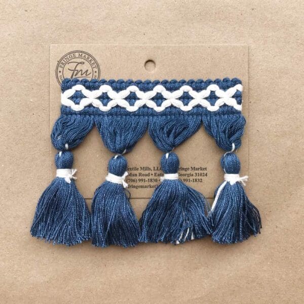 Frills Tassel Fringe 3.5 IN in blue and white on a piece of cardboard.