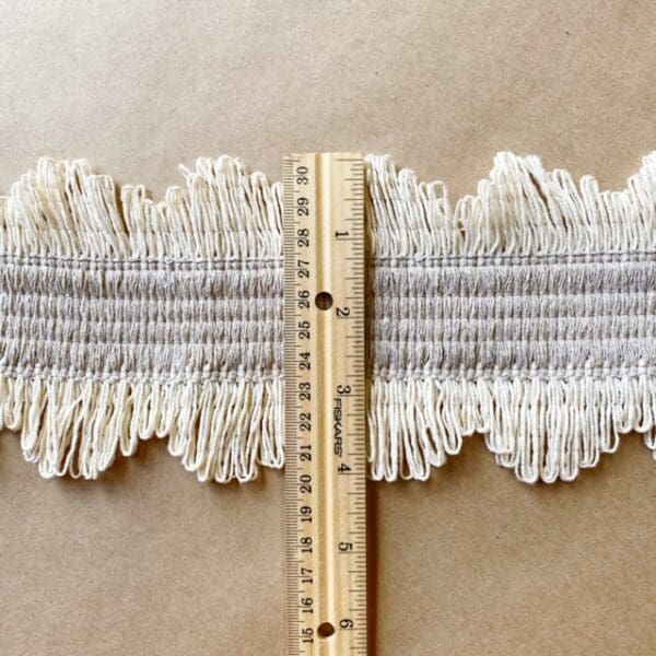 A ruler with a measuring tape and Scalloped Lace Fringe 4IN.