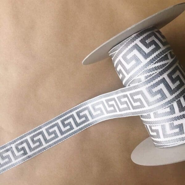 A spool of Greek Key, Silk 2 1/4 IN ribbon.