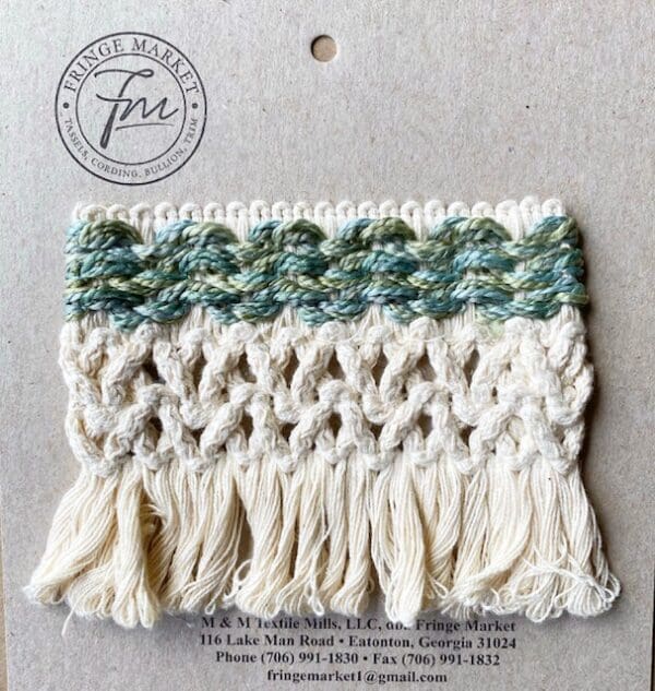 A white and green Bijoux Wide Tapes crochet tassel in a package.