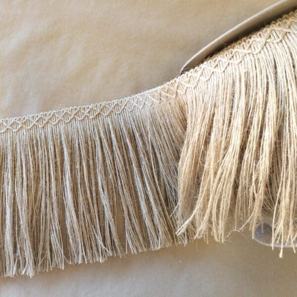 A pair of Jute 8IN Diamond Fringes on a table.