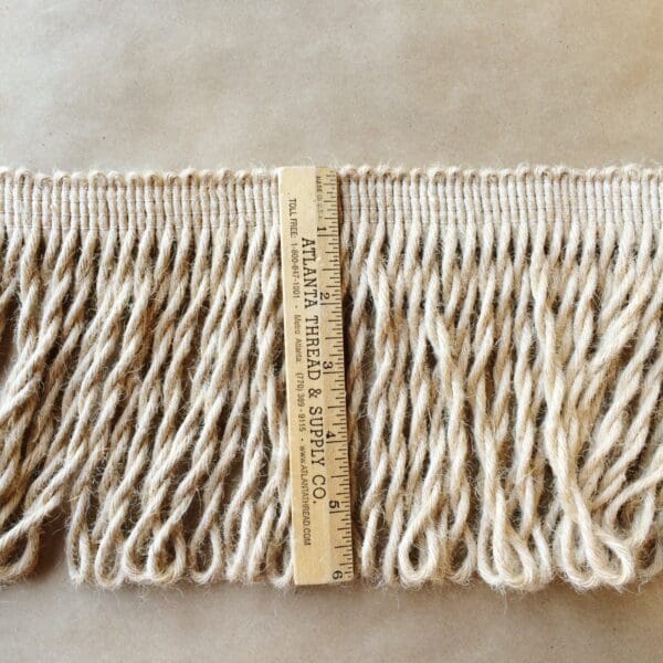 A piece of Jute Bullions 2 -10 Inches with a ruler next to it.