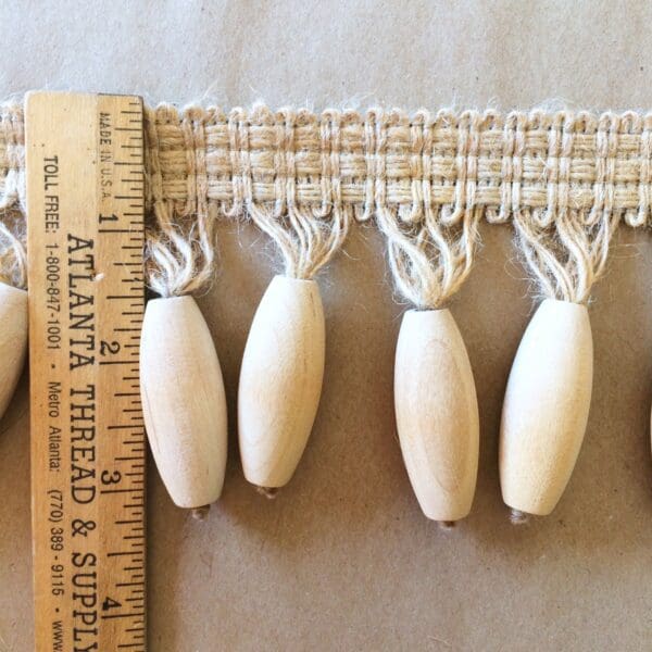 Jute with Bead Tassel Fringe tassels with a ruler next to them.