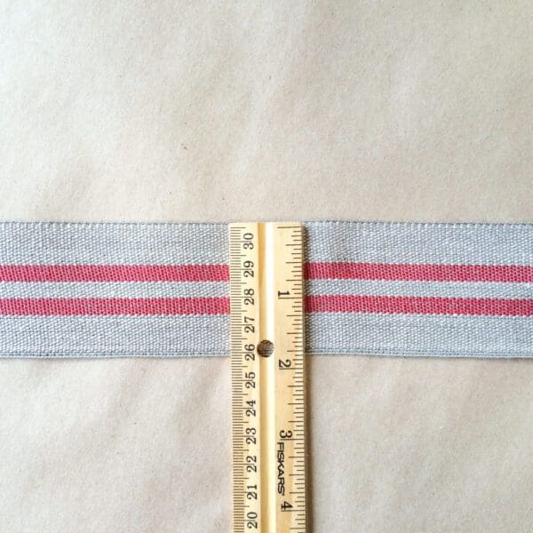 A Modern Grain Sack is used to measure the length of a strip of fabric.