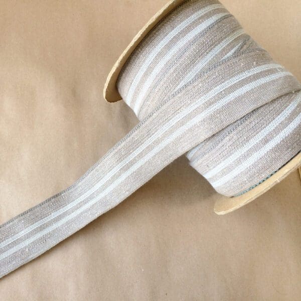 A Modern Grain Sack striped ribbon on a spool.