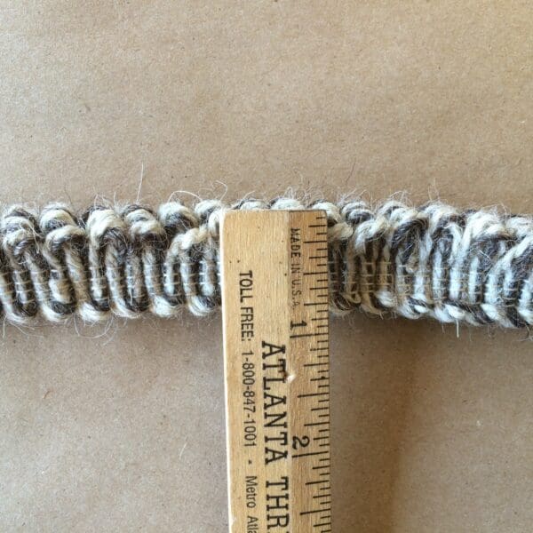 A Nubby Fringe Wool-Natural & Dark Brown crocheted belt with a ruler next to it.