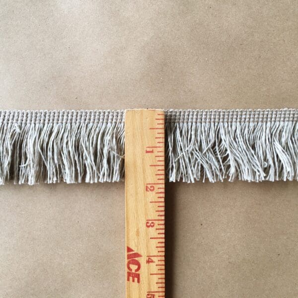 A ruler with a Outdoor 2IN Cut Brush Fringe and a measuring tape.
