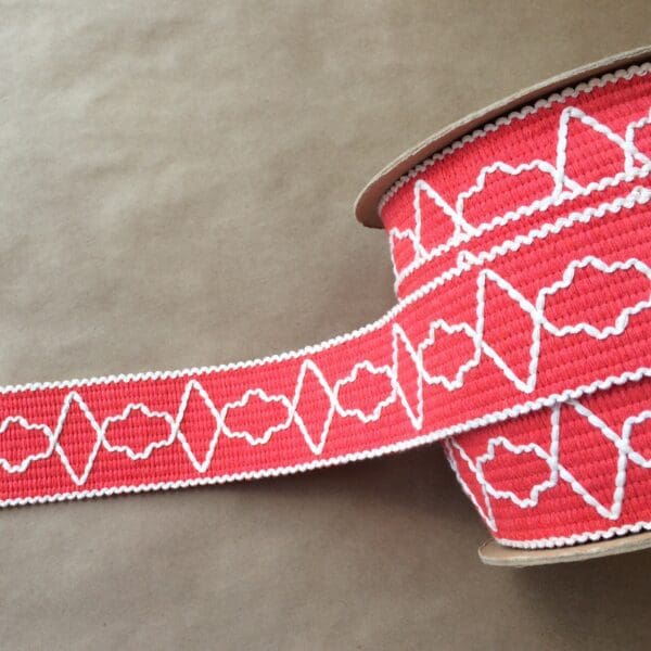 A red and white Quincy Tapes with a pattern on it.